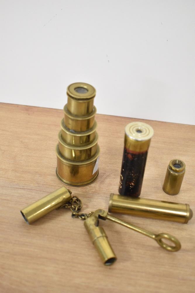 A Victorian brass telescopic spyglass, measuring 9cm long, together with another spyglass and