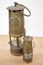 A 20th Century Eccles miner's lamp, Type 6, measuring 25cm tall, together with a miniature miner's