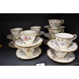 A collection of 19th Century continental porcelain teacups and saucers, hand decorated in a