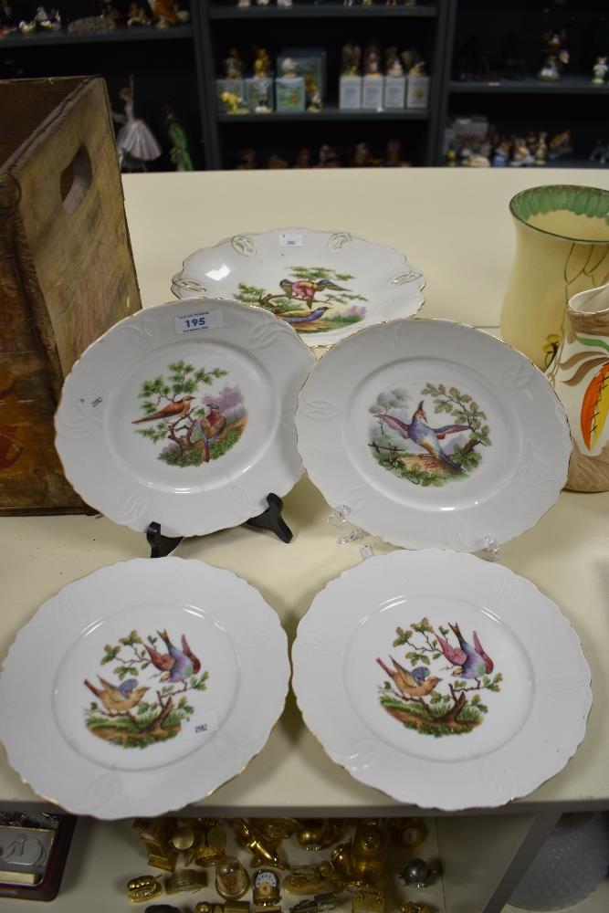 A continental porcelain comport decorated with exotic birds on cream ground, sold together with four