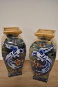 A pair of mid-20th Century glazed pottery vases of baluster form, decorated with exotic birds,