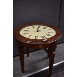 A vintage stained wood coffee table, having an integral working clock within, measuring 55cm tall