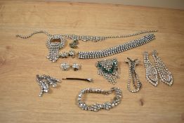 A collection of paste set costume jewellery including articulated drop brooches, screw-back drop