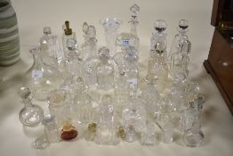 A large selection of vintage perfume bottles, a vase and dressing table items, many cut glass