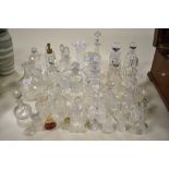 A large selection of vintage perfume bottles, a vase and dressing table items, many cut glass