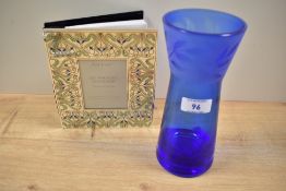 A Caithness etched blue glass vase, stamped to the underside and of waisted form, measuring 20cm