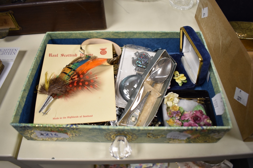 An assortment of costume brooches including paste set floral examples, enamelled examples and