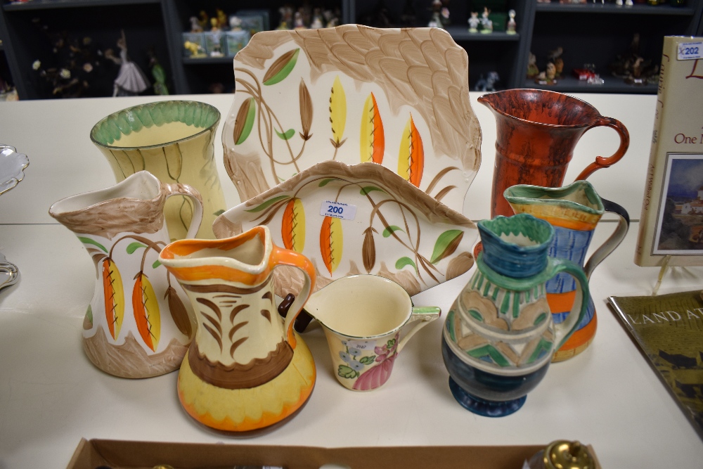 A selection of bright Art Deco hand painted Myott Pottery, including jugs, plate and vases.