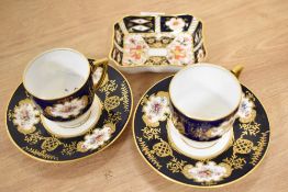 Two Victorian Coalport navy blue and white cabinet cups and saucers, and a Royal Crown Derby