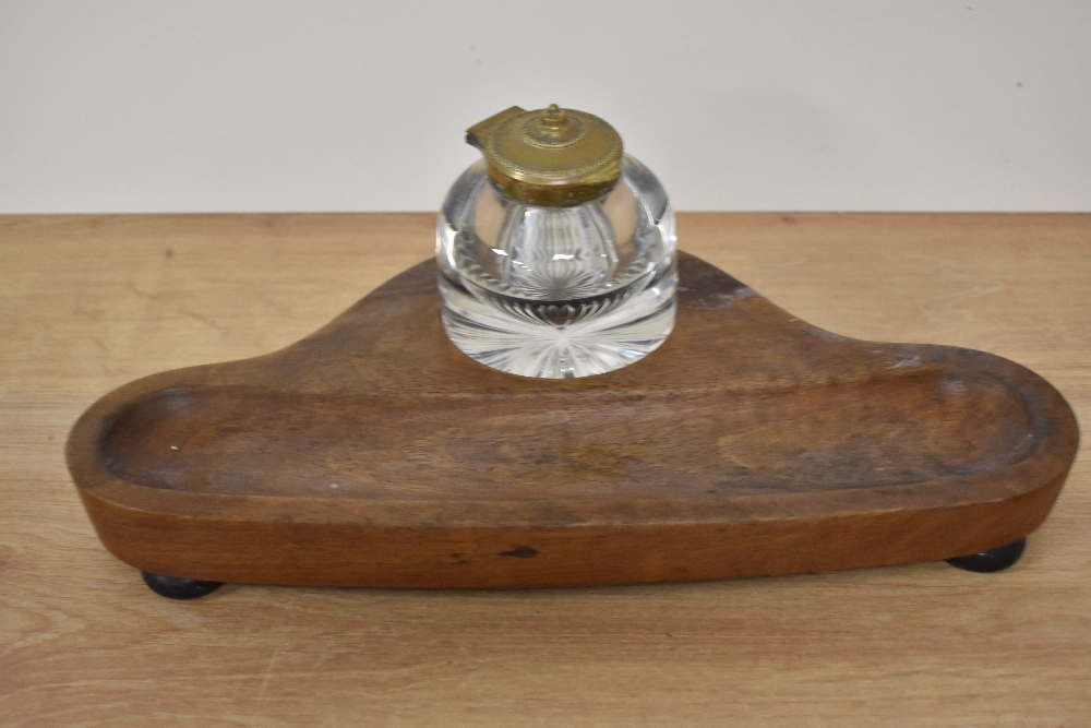 A Victorian mahogany desk stand, having glass inkwell, and raised on three bun feet, measuring