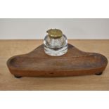 A Victorian mahogany desk stand, having glass inkwell, and raised on three bun feet, measuring