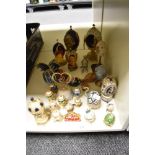 A collection of decorative ornamental egg shaped trinket boxes, some with scenes inside and