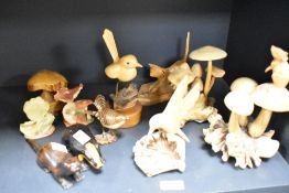 A selection of hand carved wooden animal studies, including mice and mushrooms, hummingbird, and