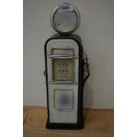 A vintage tin money box in the form of a petrol pump