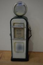 A vintage tin money box in the form of a petrol pump