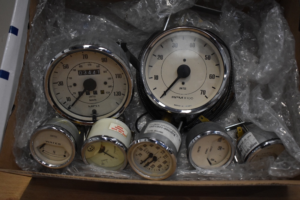 A box of automobile gauges with Magnolia faces including Speedometer, Rev counter, Amp, Water/Oil,