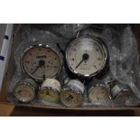 A box of automobile gauges with Magnolia faces including Speedometer, Rev counter, Amp, Water/Oil,