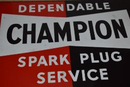 A double sided vintage metal Champion Spark Plug Service sign