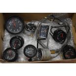 A box of automobile gauges with Black faces including Rev counter, Volt, Water/Oil, Oil x 3 and