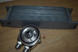 A Morris Minor oil cooler system including sandwich plate, thermostat and pipes