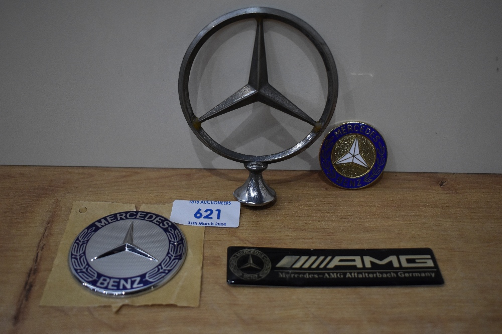 Four Mercedes car badges