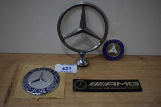 Four Mercedes car badges