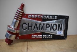 A Champion Spark Plugs advertising plaque