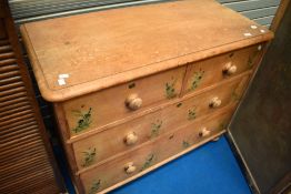 A stripped pine chest of two over two drawers , width approx 106cm, with stencilled naturalistic