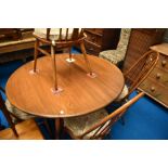 An Ercol dining set comprising drop leaf table and set of four swan back chairs