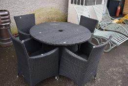 A modern plastic wicker effect garden table and four chairs