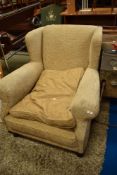 A modern cream upholstered armchair