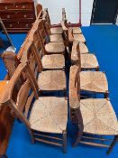 Twelve traditional chapel chairs having book shelf to back and rush seats
