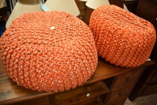 A pair of vintage knitted wool pouffe stools, in orange