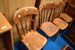A set of four 19th Century kitchen chairs having spindle backs and H stretcher