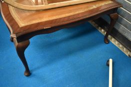 A reproduction coffee table having inset glass top with leather under, approx 99 x 60cm