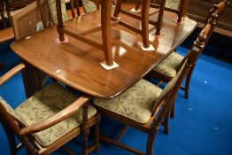 An Ercol extending dining table and eight (six plus two chairs) , length 159 plus three leaves of