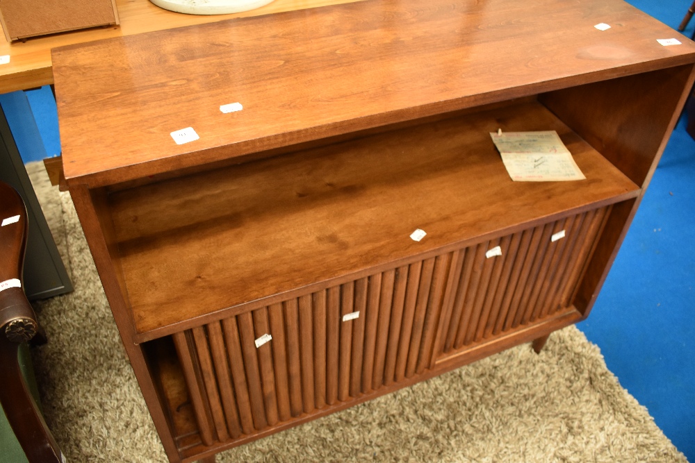 A vintage sapele and walnut shelf/cocktail cabinet having open shelf and concealed cupboard behind