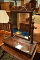 A 19th Century toilet mirror having platform base and elaborate supports