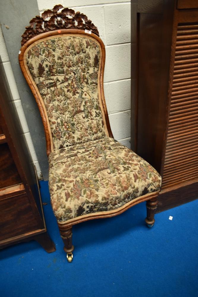 A 19th Century nursing chair having carved acorn decoration to frame, with later traditional