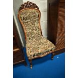 A 19th Century nursing chair having carved acorn decoration to frame, with later traditional