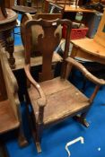 A period oak rocker having vase back and solid seat , some historical worm been treated