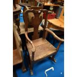 A period oak rocker having vase back and solid seat , some historical worm been treated