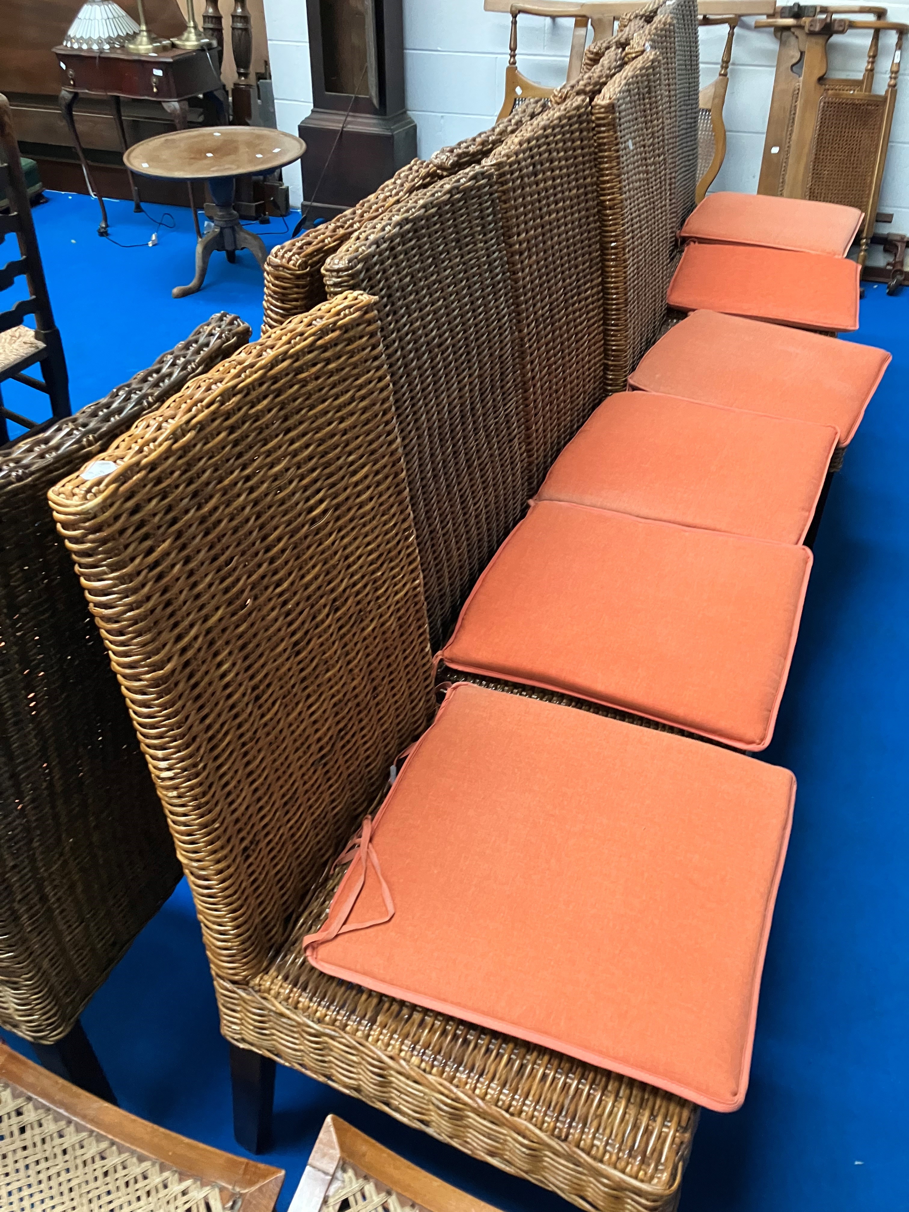 A set of twelve hardwood and wicker dining chairs