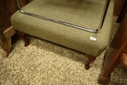 A modern oversized footstool having tweed upholstery