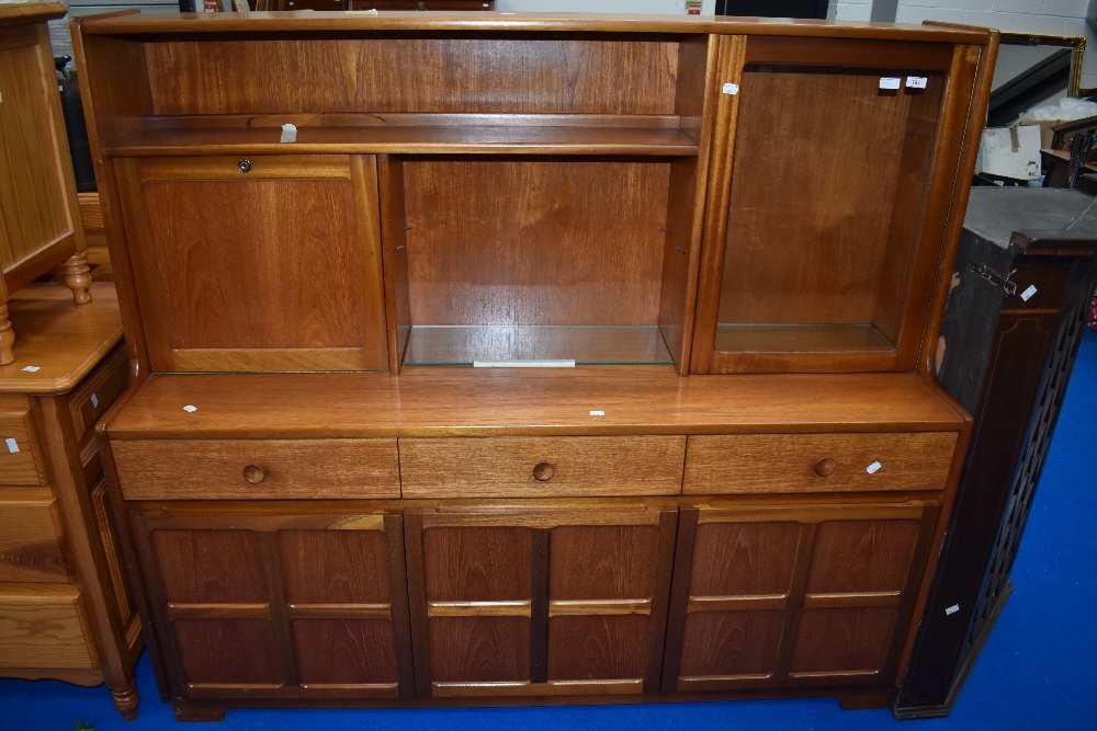 A vintage teak sideboard/dresser by Nathan, having cocktail and display section over triple frieze