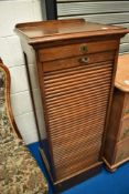 A late 19th Century or early 20th Century oak music or office cabinet having tambour front