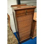 A late 19th Century or early 20th Century oak music or office cabinet having tambour front