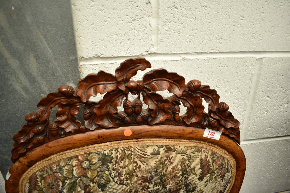 A 19th Century nursing chair having carved acorn decoration to frame, with later traditional - Image 2 of 2