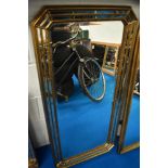 A Deknudt Decora gilt frame with mirror facets, angled corners, approx 55 x 115 cm