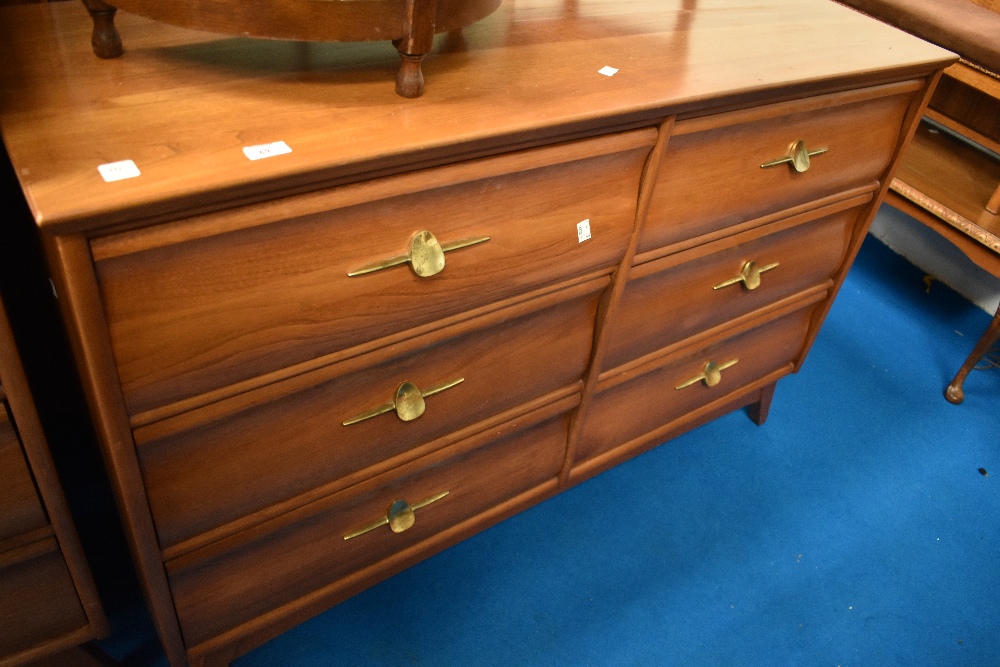 A vintage chest of four by four stylised drawers, with dressing table mirror and support arms,